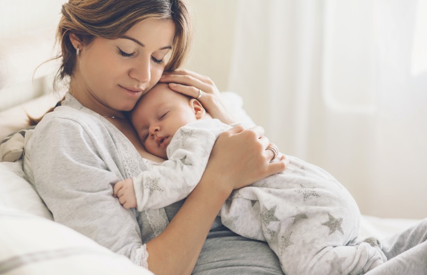 sleeping baby in moms hands